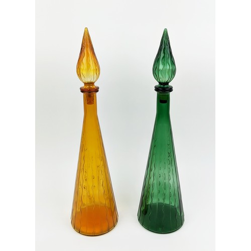 3 - A PAIR OF ITALIAN STYLE DECANTERS, of conical form, one in green, the other in amber, each measuring... 