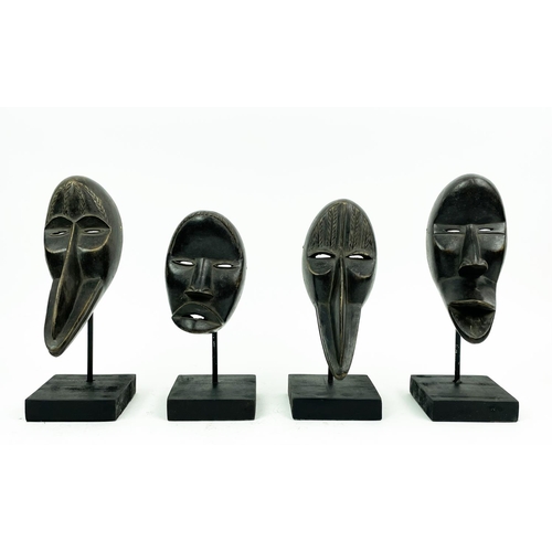 16 - SET OF FOUR DAN MASKS (Ivory Coast), 30cm H.