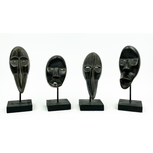 16 - SET OF FOUR DAN MASKS (Ivory Coast), 30cm H.