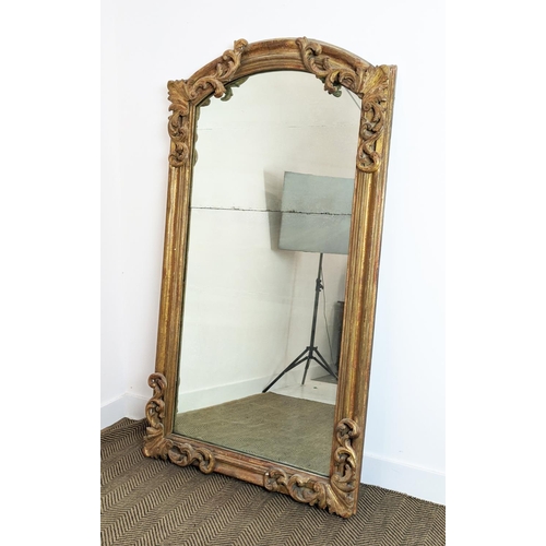 180 - WALL MIRROR, early 19th century Continental giltwood and gesso with arched foliate scrolling frame a... 