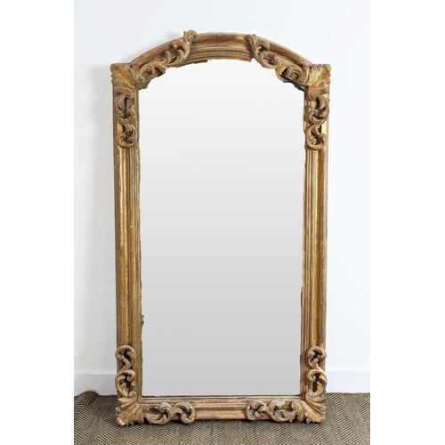 180 - WALL MIRROR, early 19th century Continental giltwood and gesso with arched foliate scrolling frame a... 