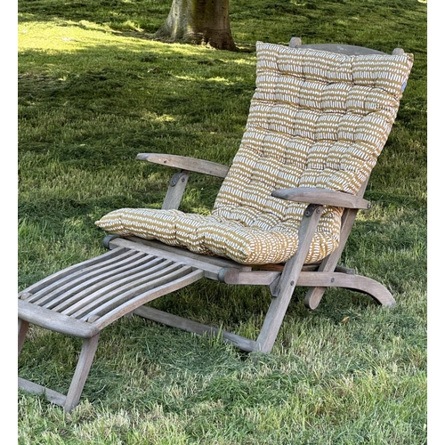 108 - GARDEN STEAMER CHAIR BY ALEXANDER ROSE, nicely weathered teak reclining with foot rest and cushions,... 