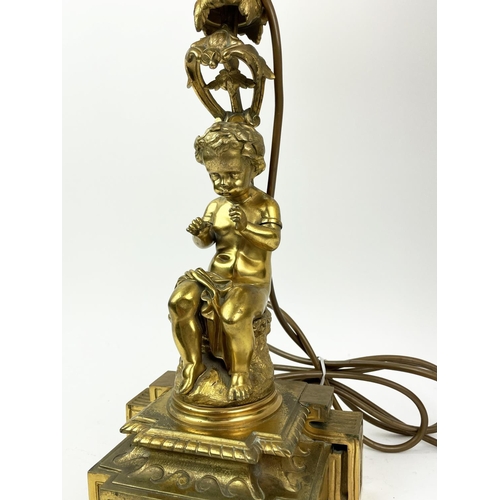 11 - LAMPS, two neo-classical style bronze and gilt bronze putti, with silk shades. (2)