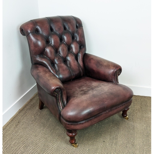 492 - FLEMING AND HOWLAND CHESTERFIELD ARMCHAIR, mahogany and burgundy leather on brass castors, 98cm H x ... 