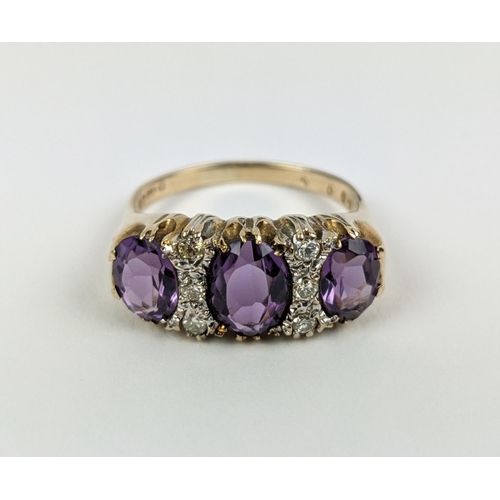 18 - A 9CT GOLD AMETHYST AND DIAMOND DRESS RING, set with three mixed cut amethysts with diamond set spac... 