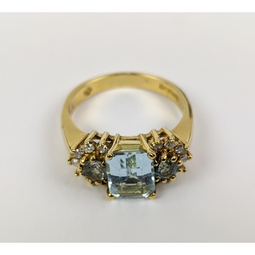 22 - AN 18CT GOLD AQUAMARINE AND DIAMOND SET DRESS RING, set with one large aquamarine and two smaller st... 