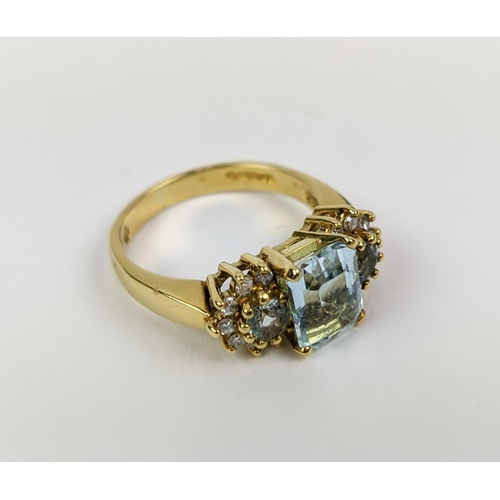 22 - AN 18CT GOLD AQUAMARINE AND DIAMOND SET DRESS RING, set with one large aquamarine and two smaller st... 