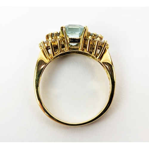 22 - AN 18CT GOLD AQUAMARINE AND DIAMOND SET DRESS RING, set with one large aquamarine and two smaller st... 