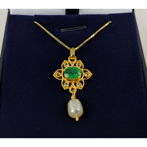 26 - A YELLOW METAL EMERALD AND PEARL SET PENDANT NECKLACE, gold plated chain, complete with box