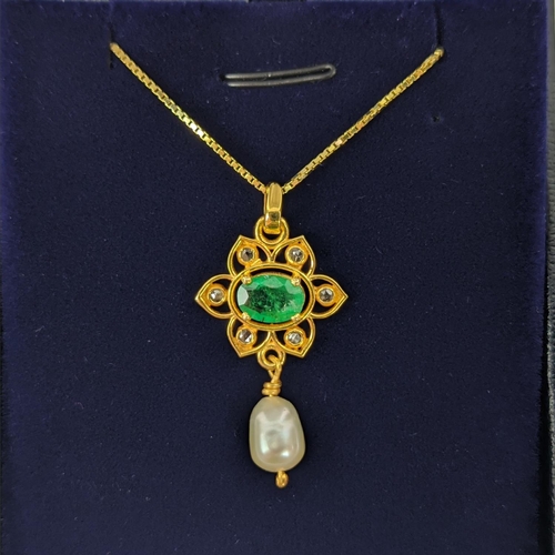 26 - A YELLOW METAL EMERALD AND PEARL SET PENDANT NECKLACE, gold plated chain, complete with box