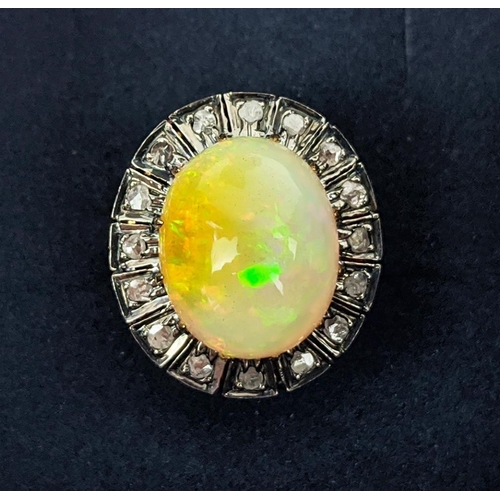 27 - A 14CT GOLD OPAL AND DIAMOND SET DRESS RING, the cabouchon opal surrounded by a halo of diamonds, ri... 