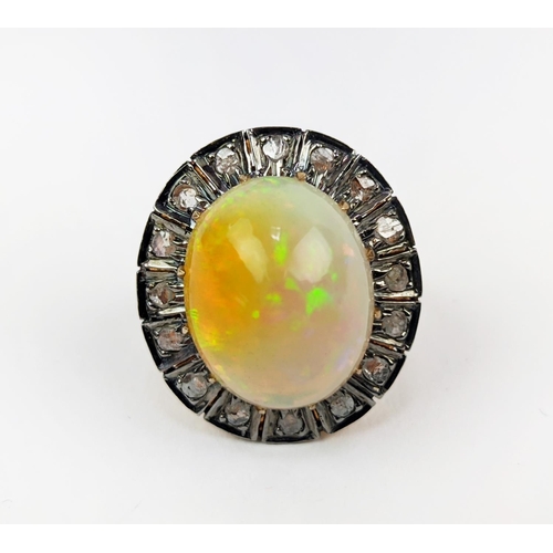 27 - A 14CT GOLD OPAL AND DIAMOND SET DRESS RING, the cabouchon opal surrounded by a halo of diamonds, ri... 