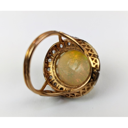 27 - A 14CT GOLD OPAL AND DIAMOND SET DRESS RING, the cabouchon opal surrounded by a halo of diamonds, ri... 