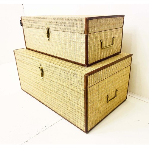 383 - TRUNKS, a graduated set of two, woven upholstered finish, largest 65cm W x 31cm H. (2)