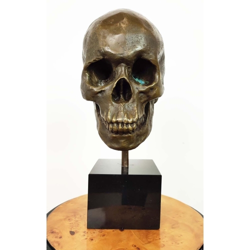 437 - CONTEMPORARY SCHOOL SCULPTURE, of a skull on a black base, 36cm H.