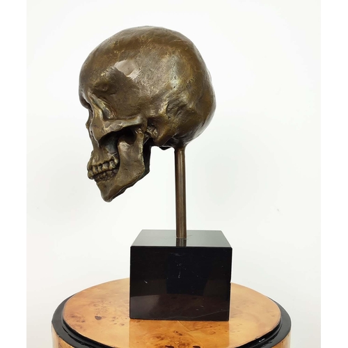 437 - CONTEMPORARY SCHOOL SCULPTURE, of a skull on a black base, 36cm H.