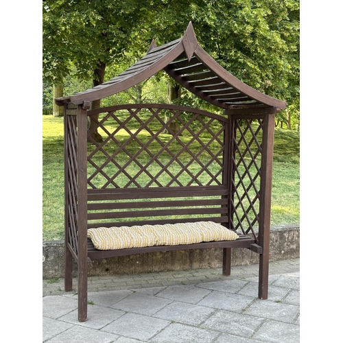 253 - GARDEN GAZEBO, vintage with pitched gable roof trellis back and slatted seat with cushion, 220cm H x... 
