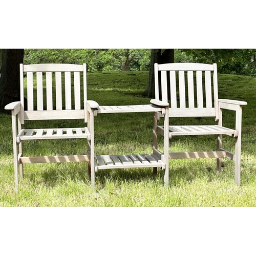 257 - GARDEN CONVERSATION BENCH, well weathered teak, two armchairs with conjoining table, 162cm W.