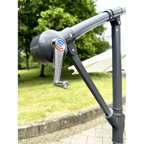 251 - SUN UMBRELLA, circular retractable with cantilever wind up support and weighted (water) bases.