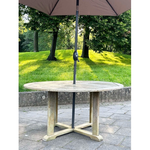 154 - GARDEN TABLE, circular well weathered teak with cross stretchered supports, 150cm W x 73cm H.