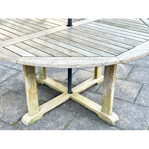 154 - GARDEN TABLE, circular well weathered teak with cross stretchered supports, 150cm W x 73cm H.