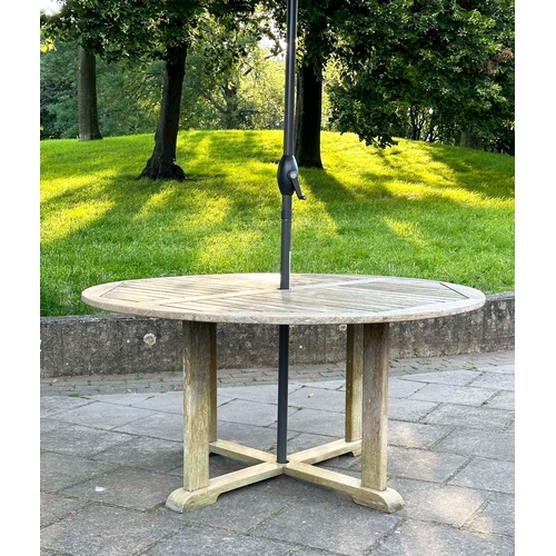 154 - GARDEN TABLE, circular well weathered teak with cross stretchered supports, 150cm W x 73cm H.