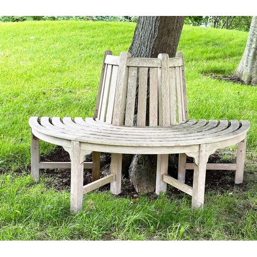 156 - GARDEN TREE BENCH, nicely weathered teak of demilune form, 90cm H x 151cm W x 42cm D.