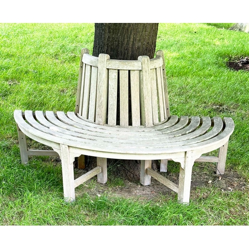 156 - GARDEN TREE BENCH, nicely weathered teak of demilune form, 90cm H x 151cm W x 42cm D.