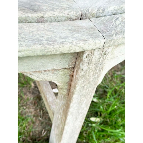 156 - GARDEN TREE BENCH, nicely weathered teak of demilune form, 90cm H x 151cm W x 42cm D.