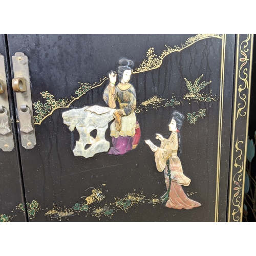 172 - SIDE CABINETS, a pair, Chinese black lacquer, gilt and relief decorated, each with two doors, 77cm H... 