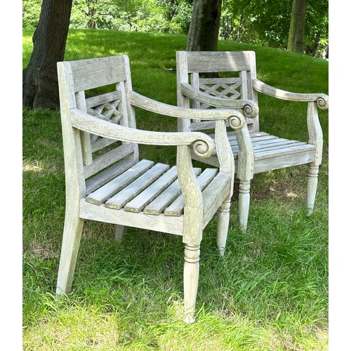 150 - COLONIAL STYLE GARDEN ARMCHAIRS, a pair, nicely weather high grade teak, each with pierced trellis c... 