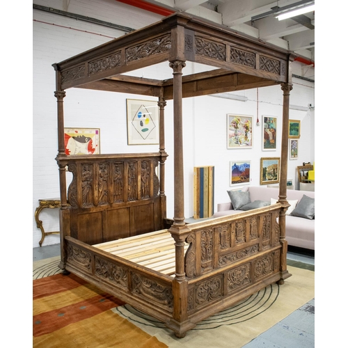 FOUR POSTER BED, late 19th/early 20th century, Medieval style, chestnut and beechwood with armorial and figure carved ends and modern pine slatted base, 263cm H x 183cm W x 224cm L, inner 161cm W.