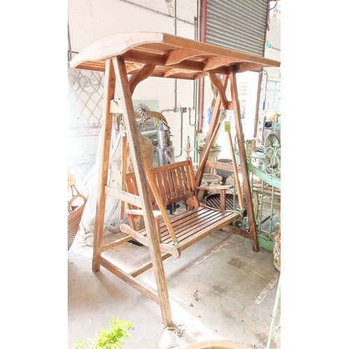 187 - GARDEN SWING SEAT, slatted teak on A frame stretched supports, 195cm H x 150cm W x 103cm D.