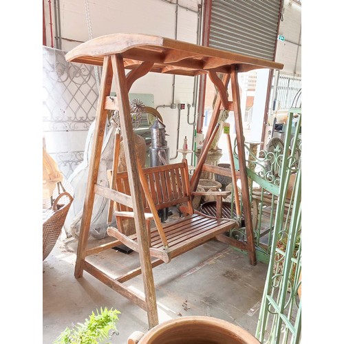 187 - GARDEN SWING SEAT, slatted teak on A frame stretched supports, 195cm H x 150cm W x 103cm D.