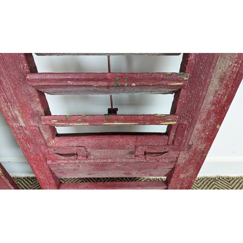 180 - PAIR OF ANTIQUE FRENCH WOODEN WINDOW SHUTTERS, late 19th/early 20th century, rustic red painted fini... 