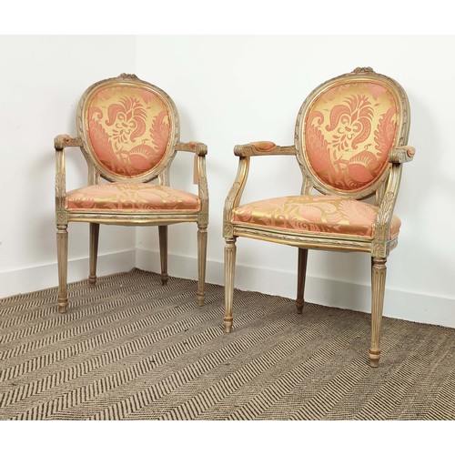 138 - FAUTEUILS, a pair, louis XVI style painted, in silk damask upholstery, with fluted supports, each 61... 