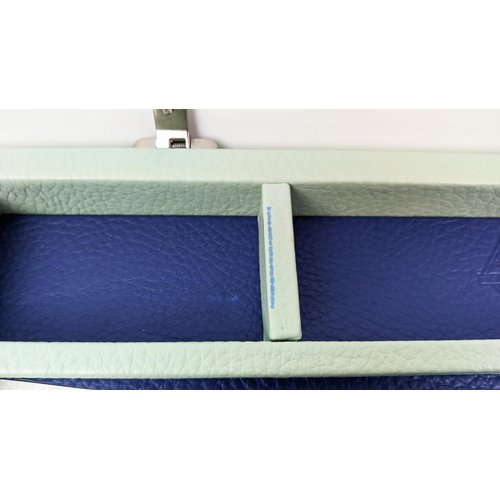 104 - GEOFFREY PARKER BACKGAMMON TRAVEL SET, in eau de nil and blue leather, 29cm x 44cm W when closed.