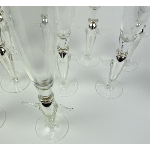 111 - ANGEL CHAMPAGNE GLASSES, a collection of eleven and a near pair of candlesticks, silver with angel w... 