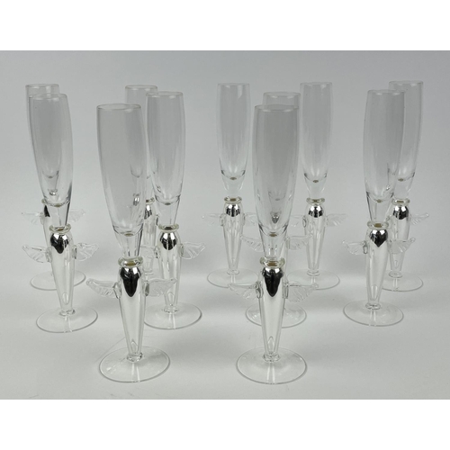 111 - ANGEL CHAMPAGNE GLASSES, a collection of eleven and a near pair of candlesticks, silver with angel w... 