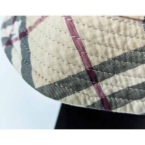 12 - BURBERRY UNISEX REVERSIBLE BUCKET HAT, iconic Burberry check pattern on one side and beige on the ot... 