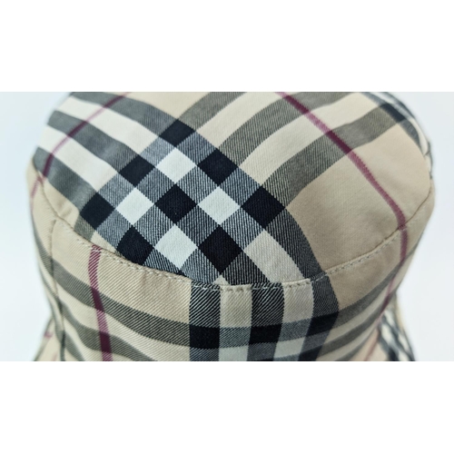 12 - BURBERRY UNISEX REVERSIBLE BUCKET HAT, iconic Burberry check pattern on one side and beige on the ot... 