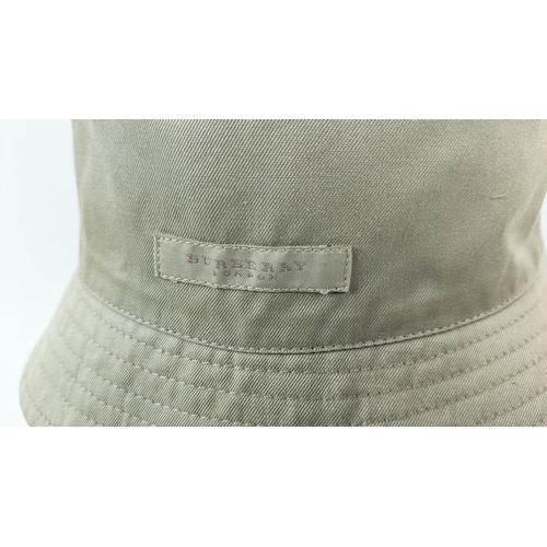 12 - BURBERRY UNISEX REVERSIBLE BUCKET HAT, iconic Burberry check pattern on one side and beige on the ot... 