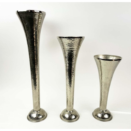 120 - FLUTED VASES, a graduated set of three, in hammered metal, 51cm H. (3)