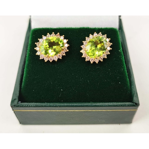 146 - A PAIR OF 18CT GOLD PERIDOT AND DIAMOND STUD EARRINGS, each with a oval mixed cut peridot
of approxi... 