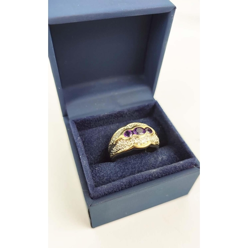 151 - A 9CT GOLD GENTS AMETHYST AND DIAMOND DRESS RING, with three oval cut amethysts and
interspaced with... 