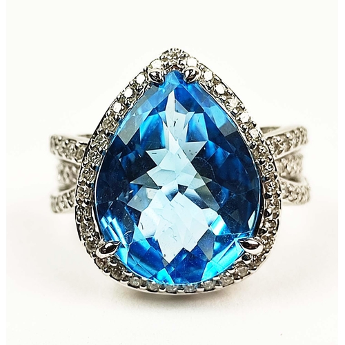 154 - AN 18CT WHITE GOLD BLUE TOPAZ AND DIAMOND SET DRESS RING, the mixed cut pear shaped Swiss Blue Topaz... 