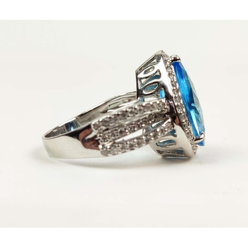 154 - AN 18CT WHITE GOLD BLUE TOPAZ AND DIAMOND SET DRESS RING, the mixed cut pear shaped Swiss Blue Topaz... 