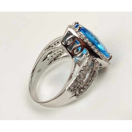 154 - AN 18CT WHITE GOLD BLUE TOPAZ AND DIAMOND SET DRESS RING, the mixed cut pear shaped Swiss Blue Topaz... 