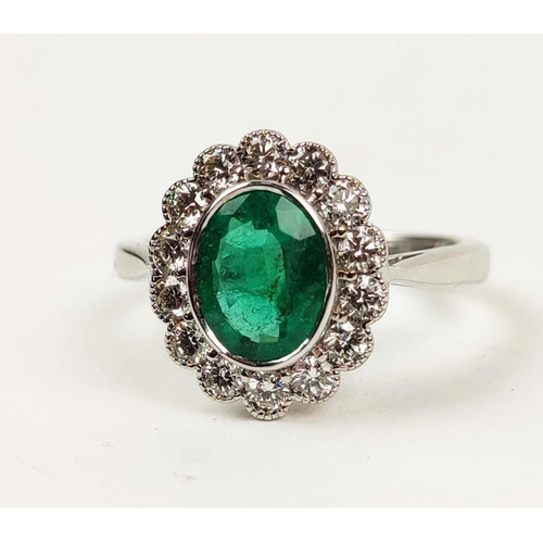 155 - AN 18CT WHITE GOLD EMERALD AND DIAMOND RING, the central oval emerald of approximately 1.08 carats, ... 