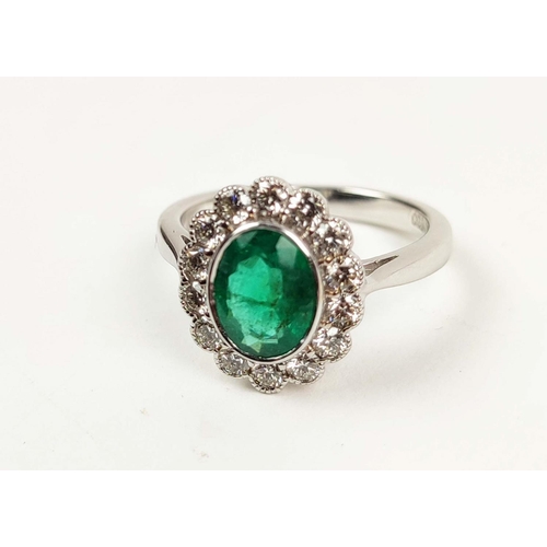 155 - AN 18CT WHITE GOLD EMERALD AND DIAMOND RING, the central oval emerald of approximately 1.08 carats, ... 